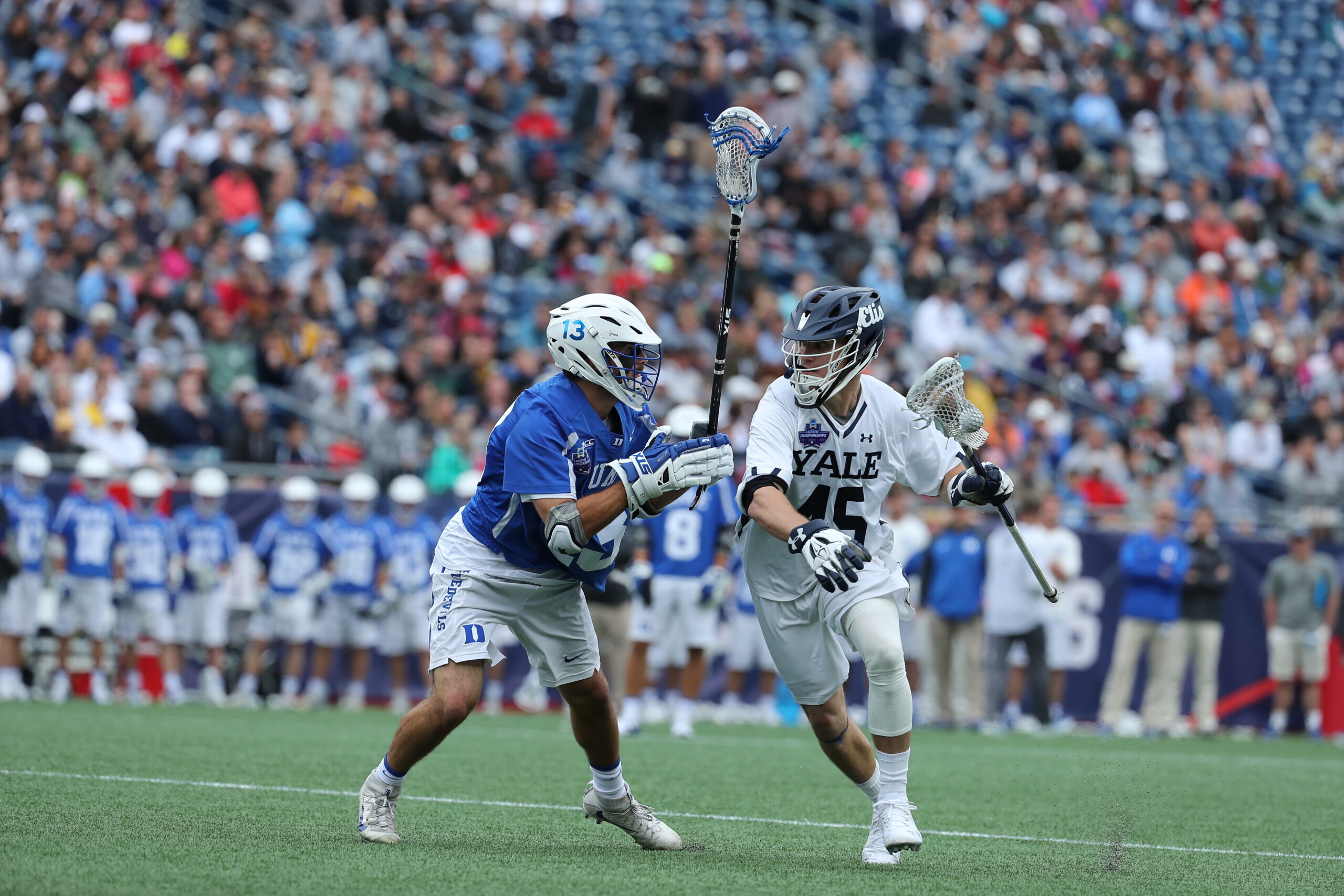 Lacrosse players playing.