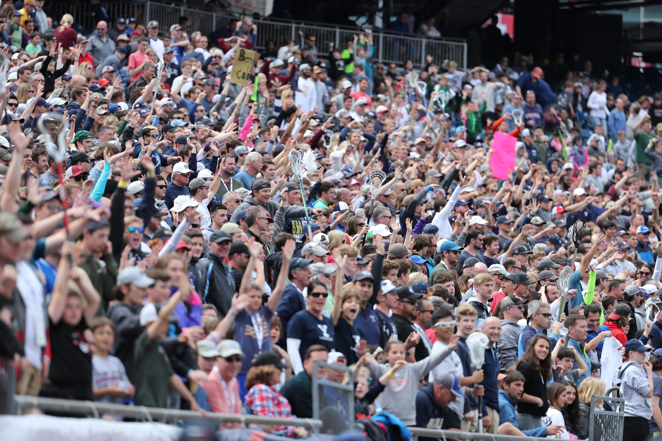 Crowd cheering during Lacrosse game.