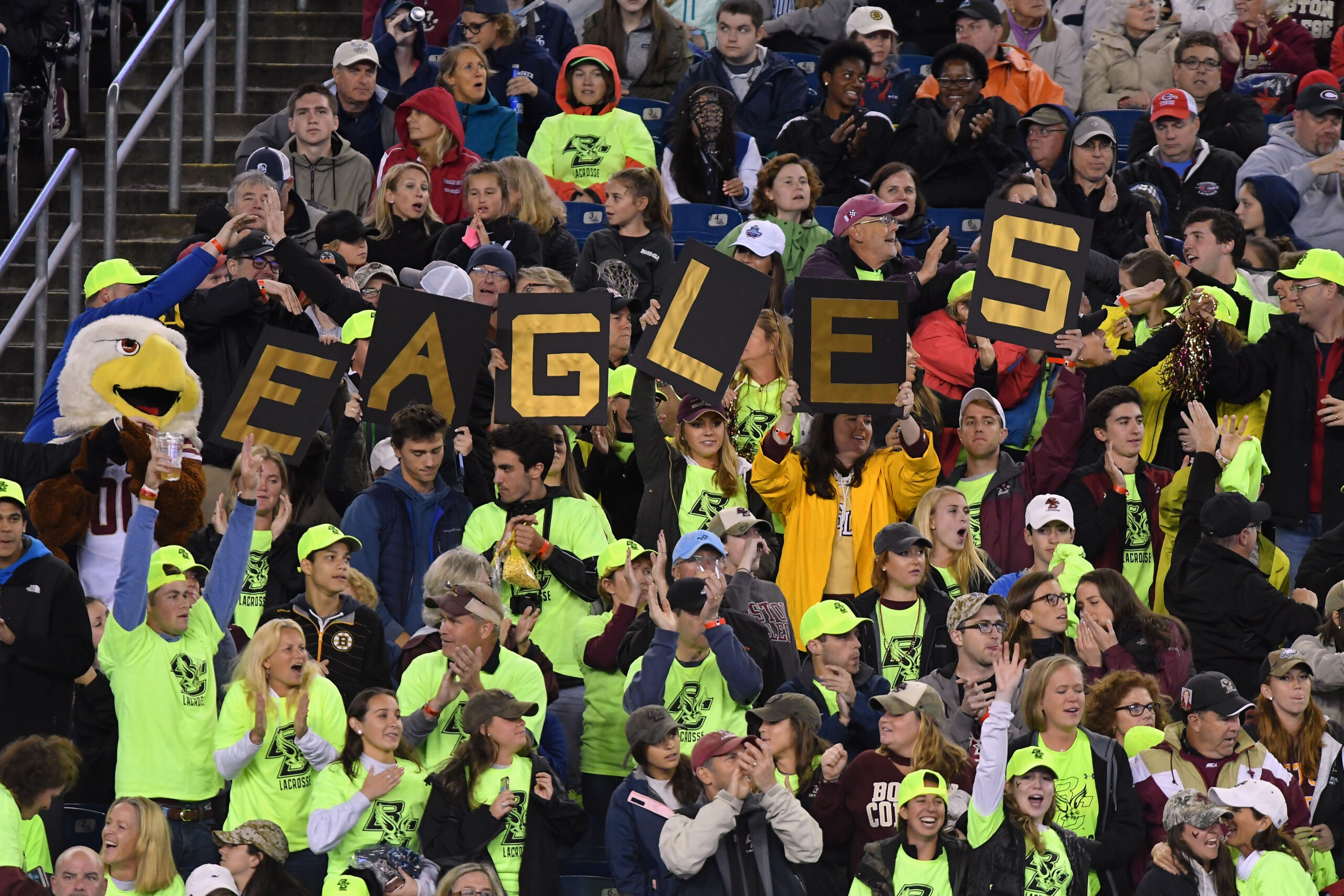 Crowd spelling 'Eagles' during a game.